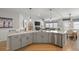 Modern kitchen with gray cabinets, stainless steel appliances, and an island with breakfast bar seating at 627 Macintyre Cir, Summerville, SC 29486