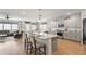Bright, open kitchen with gray cabinets, stainless appliances, a large island, and hardwood floors at 627 Macintyre Cir, Summerville, SC 29486