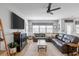 Inviting living room with a leather sectional sofa, fireplace, ceiling fan, and natural light at 627 Macintyre Cir, Summerville, SC 29486
