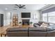 Comfortable living room with dark leather sectional, fireplace, ceiling fan, and natural light at 627 Macintyre Cir, Summerville, SC 29486