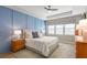 Spacious main bedroom with blue accent wall, soft carpet, ceiling fan and natural light at 627 Macintyre Cir, Summerville, SC 29486
