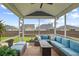 Covered patio with comfortable seating and views of the backyard and neighborhood at 627 Macintyre Cir, Summerville, SC 29486