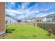 Large fenced backyard, great for pets and entertaining, with lush green lawn and view of surrounding homes at 661 Black Pine Rd, Moncks Corner, SC 29461