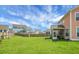 Backyard shows fenced lawn, a screened porch on a house, with neighbors under a partly cloudy sky at 661 Black Pine Rd, Moncks Corner, SC 29461