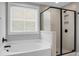 Modern bathroom showcasing a glass shower and tub with black hardware at 661 Black Pine Rd, Moncks Corner, SC 29461