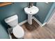Powder bathroom with white pedestal sink and wood-look floors at 661 Black Pine Rd, Moncks Corner, SC 29461