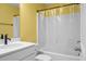 This bathroom features a sleek white vanity, toilet, and a shower-tub with a transparent curtain at 661 Black Pine Rd, Moncks Corner, SC 29461