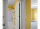 A full bathroom is presented with a shower-tub combo, white marble floor, and yellow walls at 661 Black Pine Rd, Moncks Corner, SC 29461
