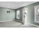 Bright bedroom with mounted TV bracket and exterior door to outdoor balcony at 661 Black Pine Rd, Moncks Corner, SC 29461
