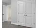 Bedroom with carpet, features a pair of double doors, and a doorway to another room at 661 Black Pine Rd, Moncks Corner, SC 29461