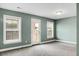 Spacious bedroom with three windows offering natural light and exterior door to balcony at 661 Black Pine Rd, Moncks Corner, SC 29461