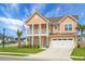 Well-maintained two-story home with a cozy front porch, a lush lawn, and a two-car garage at 661 Black Pine Rd, Moncks Corner, SC 29461