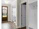 Foyer with hardwood floors, white trim and ample storage leading to the front door at 661 Black Pine Rd, Moncks Corner, SC 29461