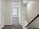 This hallway has neutral paint and carpet, leading to a window-lit room at 661 Black Pine Rd, Moncks Corner, SC 29461