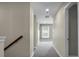 Neutral hallway with carpet, lighting, and view of a window at the end of the hall at 661 Black Pine Rd, Moncks Corner, SC 29461