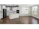 Modern kitchen features stainless steel appliances, white cabinetry, and an island overlooking living space at 661 Black Pine Rd, Moncks Corner, SC 29461