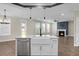 Modern kitchen featuring stainless steel appliances, white cabinetry, and a peninsula island with a farmhouse sink at 661 Black Pine Rd, Moncks Corner, SC 29461