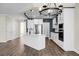 Beautiful kitchen features stainless steel appliances, white cabinets, large island and modern lighting at 661 Black Pine Rd, Moncks Corner, SC 29461
