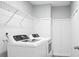 Bright laundry room featuring updated washer and dryer, wire rack shelving and modern decor at 661 Black Pine Rd, Moncks Corner, SC 29461