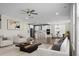 Open-concept living room with white furniture, hardwood floors, recessed lighting, and an adjoining kitchen at 661 Black Pine Rd, Moncks Corner, SC 29461