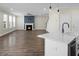 Open floor plan with wood floors and fireplace adjacent to modern kitchen at 661 Black Pine Rd, Moncks Corner, SC 29461