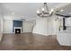 Open living room with fireplace, hardwood floors, modern decor, and open staircase at 661 Black Pine Rd, Moncks Corner, SC 29461