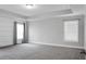 Bright main bedroom with neutral walls, and two windows with curtains and blinds at 661 Black Pine Rd, Moncks Corner, SC 29461