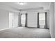 Spacious main bedroom with carpet flooring, neutral walls, and two windows at 661 Black Pine Rd, Moncks Corner, SC 29461