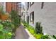 Unique alley view is accented with lush plants and exposed brick, leading to city architecture at 8 & 8 1/2 Elliott St # 8 & 8 1/2, Charleston, SC 29401