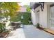 Private backyard patio with lush greenery, charming ivy wall, and outdoor dining set at 8 & 8 1/2 Elliott St # 8 & 8 1/2, Charleston, SC 29401