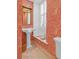 Stylish powder room with patterned wallpaper, elegant sink, and bright window at 8 & 8 1/2 Elliott St # 8 & 8 1/2, Charleston, SC 29401