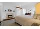 Bright bedroom with a king-size bed, fireplace, and hardwood floors, offering a serene and elegant ambiance at 8 & 8 1/2 Elliott St # 8 & 8 1/2, Charleston, SC 29401