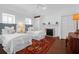 Spacious bedroom with two twin beds, fireplace, and rich hardwood floors, creating a warm, inviting atmosphere at 8 & 8 1/2 Elliott St # 8 & 8 1/2, Charleston, SC 29401