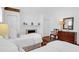 Comfortable bedroom featuring twin beds, a fireplace, and stylish furnishings for a relaxing retreat at 8 & 8 1/2 Elliott St # 8 & 8 1/2, Charleston, SC 29401