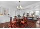 Elegant dining area features a round wood table, four chairs, and opens to a living area and brick-walled kitchen at 8 & 8 1/2 Elliott St # 8 & 8 1/2, Charleston, SC 29401