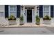 Elegant front door with decorative planters, gas lanterns, and a welcoming entrance at 8 & 8 1/2 Elliott St # 8 & 8 1/2, Charleston, SC 29401