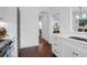 Bright transitional kitchen boasts white cabinets, stainless appliances and a view into other rooms at 8 & 8 1/2 Elliott St # 8 & 8 1/2, Charleston, SC 29401