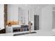 Modern kitchen features white cabinets, stainless steel appliances, brick accent wall, and a sleek design at 8 & 8 1/2 Elliott St # 8 & 8 1/2, Charleston, SC 29401