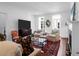 Bright living room with TV, fireplace, hardwood floors, and comfortable seating is perfect for entertaining at 8 & 8 1/2 Elliott St # 8 & 8 1/2, Charleston, SC 29401