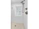 Updated shower with white tile, a rain shower head, and a window, creating a relaxing and spa-like atmosphere at 8 & 8 1/2 Elliott St # 8 & 8 1/2, Charleston, SC 29401