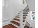 Elegant staircase with wood treads, white risers, and wrought iron railing at 8 & 8 1/2 Elliott St # 8 & 8 1/2, Charleston, SC 29401