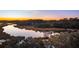 Panoramic waterfront view of tranquil inlet at sunset, framed by lush trees, and featuring a private dock at 810 Curved Creek Ct, James Island, SC 29412