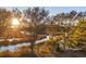 Beautiful waterfront property featuring water views with sun glistening through marsh trees at 810 Curved Creek Ct, James Island, SC 29412