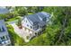 Aerial view showcasing the beautiful home, multiple car garage and screened in porch at 8605 Refuge Point Cir, North Charleston, SC 29420
