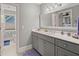 Bright bathroom with a modern vanity, white countertop, large mirror, and updated fixtures at 8605 Refuge Point Cir, North Charleston, SC 29420
