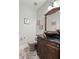 Powder room featuring a custom sink basin, wood vanity, framed seahorse artwork, and a comfort height toilet at 8605 Refuge Point Cir, North Charleston, SC 29420