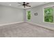 Spacious and sunny bedroom with plush carpeting, large windows, and ample natural light at 8605 Refuge Point Cir, North Charleston, SC 29420