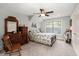 Cozy bedroom with a floral-patterned bed, wood furniture, and a window offering plenty of natural light at 8605 Refuge Point Cir, North Charleston, SC 29420