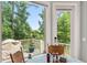 Breakfast nook features outdoor views of the deck and greenery with a table and four chairs at 8605 Refuge Point Cir, North Charleston, SC 29420