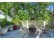 Deck with seating, greenery and a fire pit surrounded by trees and nature at 8605 Refuge Point Cir, North Charleston, SC 29420